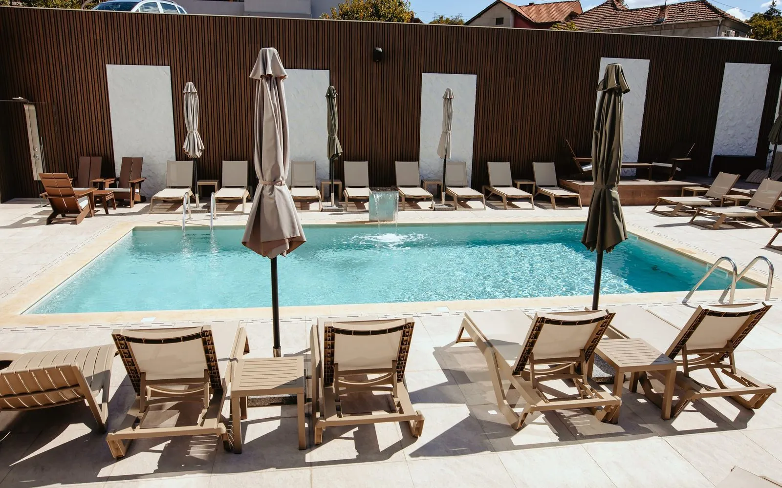 The hotel outdoor pool with sun loungers and umbrellas